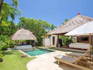 an image of a villa with a swimming pool at Novotel Bali Benoa in Nusa Dua