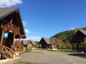 a group of wooden homes with a driveway at Awone Shirakami Juniko in Fukaura