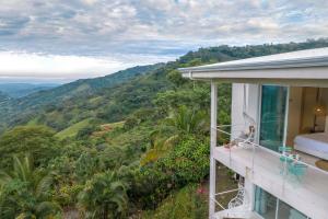 a balcony of a house with a view of the mountains at The Retreat Costa Rica - Wellness Resort & Spa in Atenas