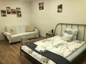 1 dormitorio con 1 cama y 1 sofá en Madách Central Apartment, en Budapest
