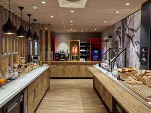 a bakery with a counter with bread on it at Ibis budget Dijon Centre Clemenceau in Dijon