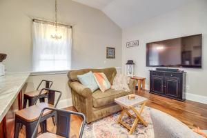 a living room with a couch and a table at Cozy Savannah Vacation Rental with Fenced Courtyard! in Savannah