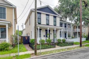a row of houses on a street at Cozy Savannah Vacation Rental with Fenced Courtyard! in Savannah