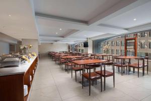 a row of tables and chairs in a restaurant at Days Inn by Wyndham Dali Erhai Park in Dali