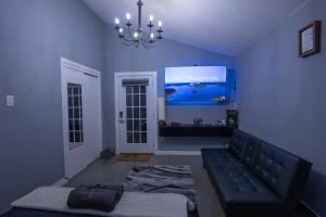 a living room with a couch and a screen at PRIVATE ROOM, BATHROOM & ENTRANCE DOOR w/ POOL in East Hampton