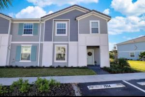 a house in a subdivision with a driveway at Orlando Relax in Davenport