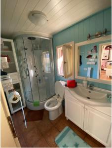 a bathroom with a shower and a toilet and a sink at Vila 10 Fshati Turistik - Ishull Lezhe, Kune Vain in Lezhë