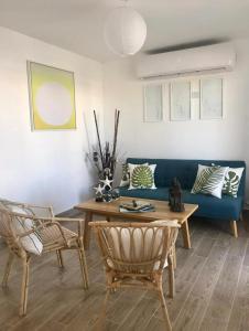 sala de estar con sofá azul, mesa y sillas en PENTHOUSE EN MONTERRICO en El Sunzo