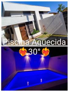 eine Villa mit Swimmingpool und ein Haus in der Unterkunft A Casa Linda Com Piscina Aquecida churrasqueira wifi pertinho da praia em Itanhaém in Itanhaém