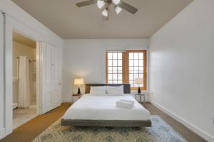 a white bedroom with a bed and a window at 2br Apartment With King Beds, Historic Charm in Louisville