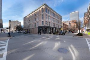an empty city street with a large white building at Historic Charm, Walkable Entertainment in Louisville
