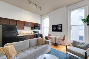 a living room with a couch and a kitchen at Historic Charm, Walkable Entertainment in Louisville