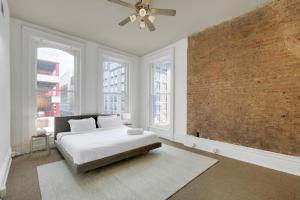 a bedroom with a bed and a brick wall at Historic Charm, Walkable Entertainment in Louisville