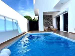 a large blue swimming pool in a house at LUXURY_VIP_Villa_LifeStyle puerto plata in San Felipe de Puerto Plata