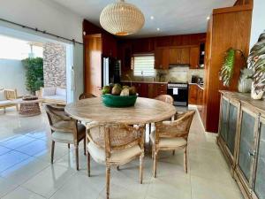 a kitchen with a table with a bowl of fruit on it at LUXURY_VIP_Villa_LifeStyle puerto plata in San Felipe de Puerto Plata