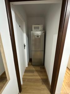 a hallway with a small refrigerator in a room at Rooms4Less in Gdańsk