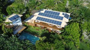 an aerial view of a house with solar panels on it at Sup House Barra Grande in Barra Grande