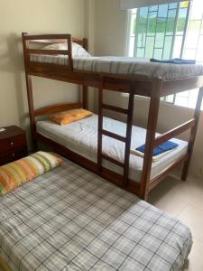 two bunk beds in a room with a mattress at Punta Blanca 5.5, Dpto Vista al mar in Punta Blanca