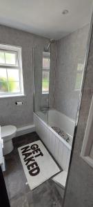 a bathroom with a shower and a toilet and a sink at Modern Town House in Mid Wales in Knighton