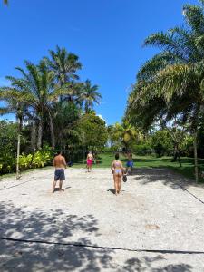 a group of people walking on the beach at Sup House Barra Grande in Barra Grande