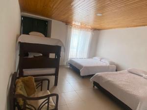 Postel nebo postele na pokoji v ubytování Hospedaje Casa Lola