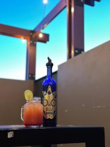 a blue bottle sitting on a table with a drink at Cooma Hotel in Cooma