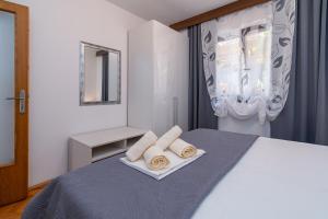 a bedroom with a bed with two towels on it at Apartment Crikvenica 5494c in Crikvenica