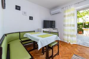a small dining room with a table and chairs at Apartment Crikvenica 5494c in Crikvenica