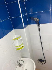 a blue and white bathroom with a toilet and a sink at Modern Moroccan apartment near the beach in Safi in Safi