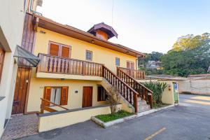a house with a staircase on the side of it at Pousada Alemã in Santo Antônio do Pinhal