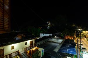 a night view of a building with solar panels on the roof at Pousada Alemã in Santo Antônio do Pinhal
