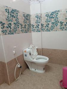 a bathroom with a toilet with a hose at SGS Residency in Tirupati