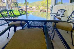 a glass table and chairs on a patio at Clearlake Charmer in Clearlake Oaks