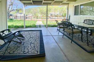 a screened in porch with a glass table and chairs at Clearlake Charmer in Clearlake Oaks
