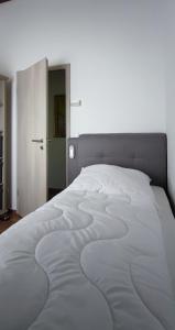 a bedroom with a large white bed with at Ferienhaus Eifelurlaub in Biersdorf