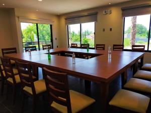 a conference room with tables and chairs and windows at Hotel La Querencia in Río Verde +60 photos