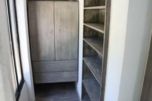 a closet with wooden shelves in a room at Casa Marcela in San José del Cabo