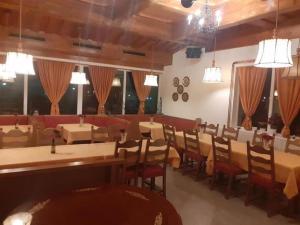 a restaurant with tables and chairs in a room at Kupreška Bajka in Kupres