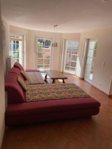 a red couch in a living room with a table at Büchling FEWO in Königswinter