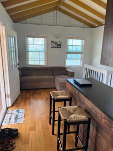 a living room with a couch and a table and chairs at Bahari in Carriacou