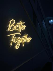 a neon sign that says better together on a building at Lovely Guest House in Kent
