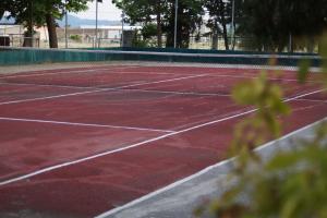 a tennis court with a net on it at Palatino in Afitos +28 photos