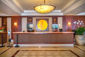 a hotel lobby with a reception desk and a light fixture at OUTRIGGER Honua Kai Resort and Spa in Lahaina