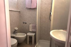 a small bathroom with a sink and a toilet at Hotel Nanda in Chianciano Terme