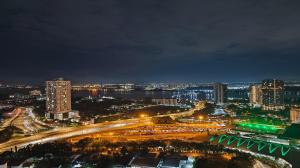 a city lit up at night with traffic on a freeway at Twin Tower Johor Bahru by Glex in Johor Bahru