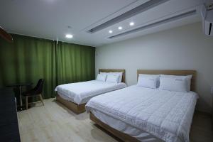 Voodi või voodid majutusasutuse VIEW Hotel Geoje toas