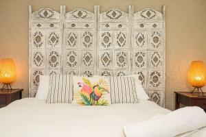 a bedroom with a white bed with two lamps at Nelson's Landing - Pet Friendly in Jervis Bay in Vincentia