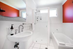 a white bathroom with a sink and a shower at Nelson's Landing - Pet Friendly in Jervis Bay in Vincentia +51 photos