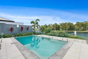 a swimming pool in the backyard of a house at OSPREY ISLAND RETREAT in Banksia Beach