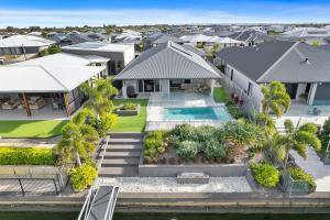 an aerial view of a house with a swimming pool at OSPREY ISLAND RETREAT in Banksia Beach
